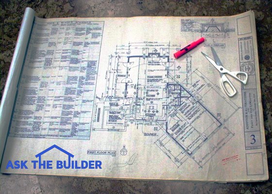 house blueprints with marker and scissors