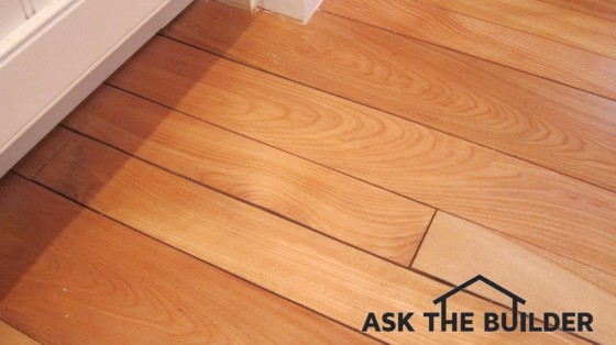 This hardwood floor got wet, swelled, then dried. Cracks are now telling the ugly tale. Photo Credit: Tim Carter