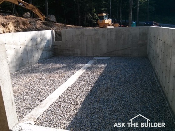 The ground to the left of the foundation must be cut back. A retaining wall will have to be built and the ground between the house and the wall must slope towards the retaining wall. Photo Credit: Tim Carter