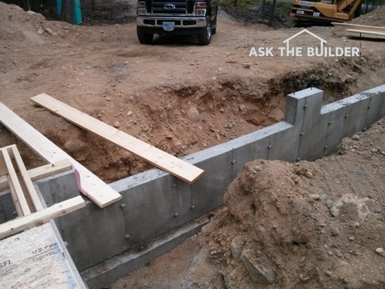 The dirt and rock in the center of the future garage has been compacted by Mother Nature for eons. But the trenches next to the new foundation require special care by the builder. Photo Credit: Tim Carter