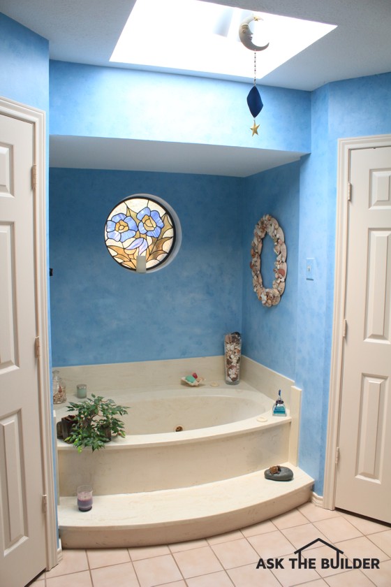 This tub is being replaced with a walk-in shower. What’s the best thing to do about the stained-glass window?. Photo Credit: Robin Pattison