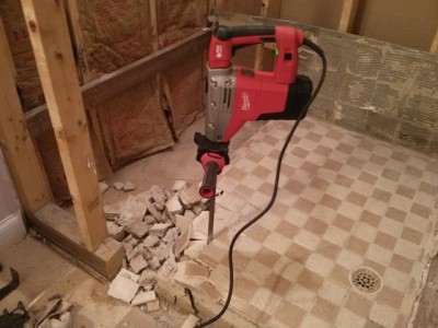Use a handy power tool like this hammer drill / chisel and your mud shower pan floor will soon be chunks of rubble. Photo Credit: Tim Carter
