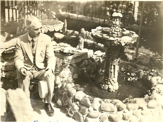 Charles Carter sitting at stone fountain
